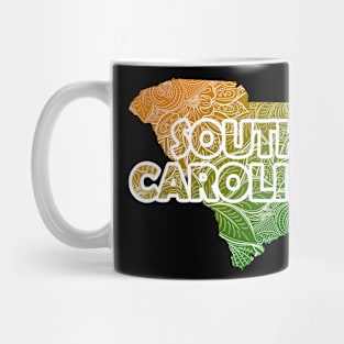 Colorful mandala art map of South Carolina with text in green and orange Mug